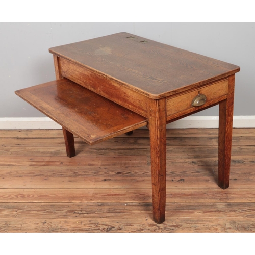 318 - A 1940's teachers desk in oak with brass plated ink wells and glass inserts, draw to either side wit... 