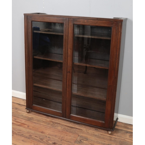 324 - Dark oak two door glazed bookcase cabinet. 

Hx124cm
Wx110cm
Dx29cm