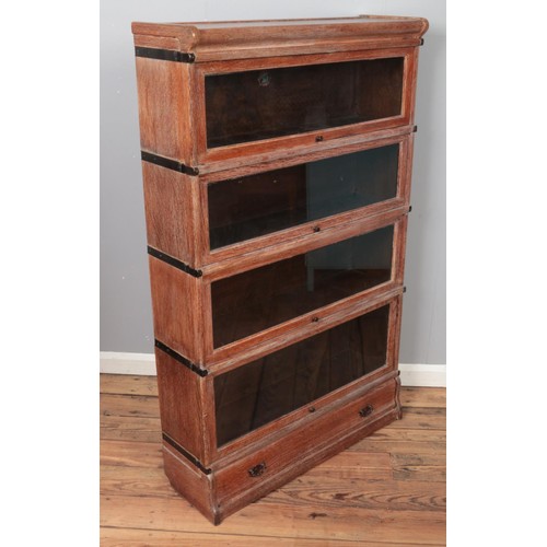 358 - An oak Globe Wernicke four section stacking bookcase. (142cm x 86cm)