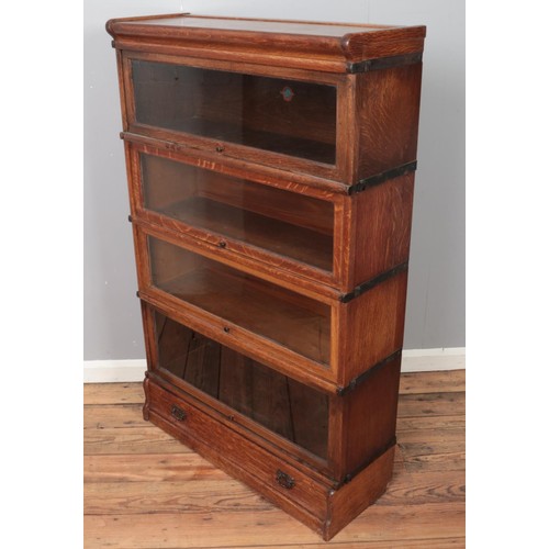 359 - An oak Globe Wernicke four section stacking bookcase. (137cm x 86cm)