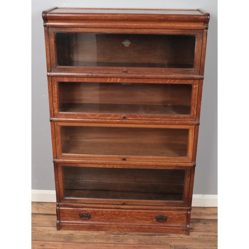 359 - An oak Globe Wernicke four section stacking bookcase. (137cm x 86cm)