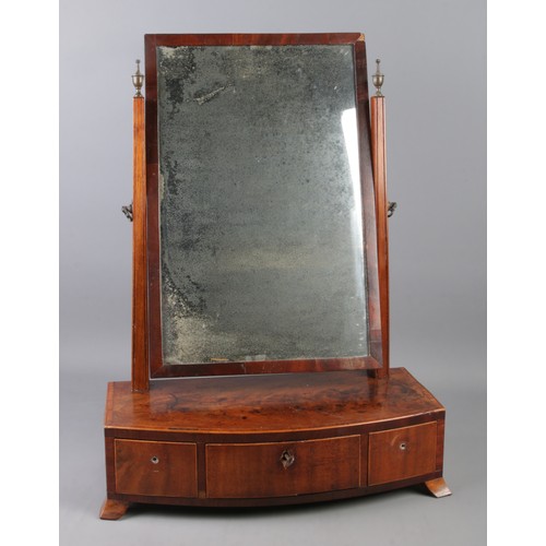 201 - A walnut toilet mirror raised on three drawers.