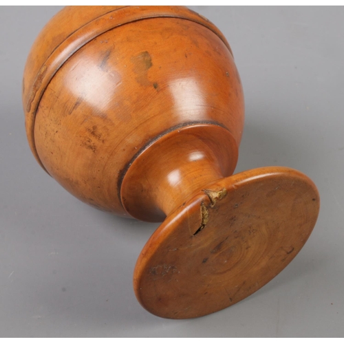 1 - A 19th century treen pill silverer with turned base. Height approximately 10cm.