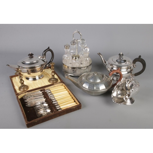 125 - A collection of metalwares. Includes condiment set, teapots, cased cutlery etc.