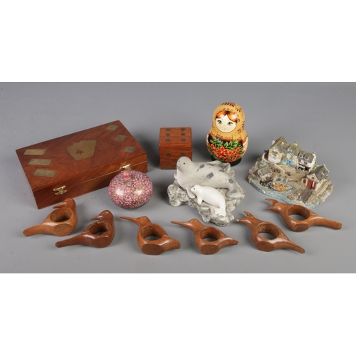 126 - A collection of wooden and ceramic items. Includes Danbury Mint Safely Home, Wooden games sets, Russ... 