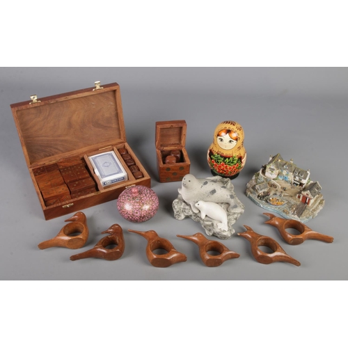 126 - A collection of wooden and ceramic items. Includes Danbury Mint Safely Home, Wooden games sets, Russ... 