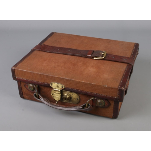 135 - A Leather, canvas and brass cartridge box with internal leather lifting straps with original makers ... 