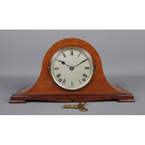 5 - A Gillett & Johnston mahogany dome top mantle clock, with banded edge and silvered Roman Numeral dia... 