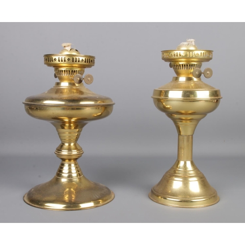 65 - Two brass oil lamp bases, both stamped 'Made in England' to the wick raisers and on the bottom.