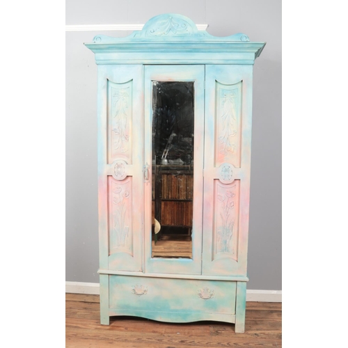 436 - A painted Victorian carved mirror front wardrobe.