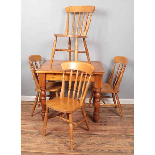 409 - A small pine kitchen table, together with four chairs. Dimensions of table: Height: 78cm, Width: 91c... 