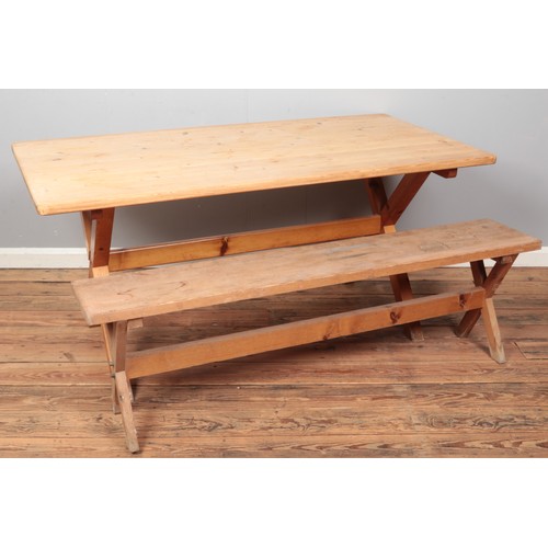 429 - A pine kitchen table with X-Frame base, together with a pine bench of similar design. 
Dimensions of... 