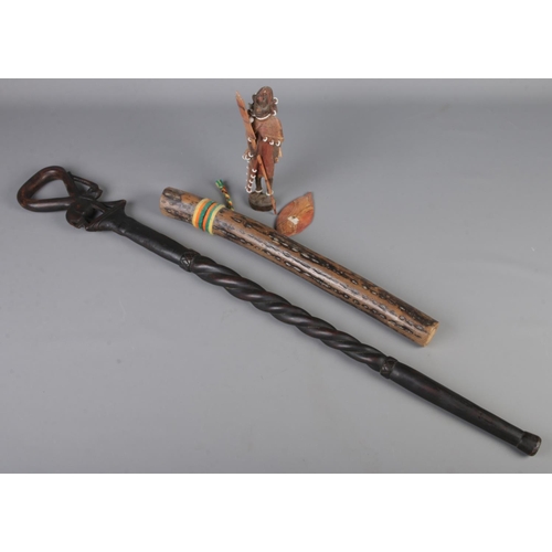 140 - An African carved walking stick along with a rain maker and African tribal figure.