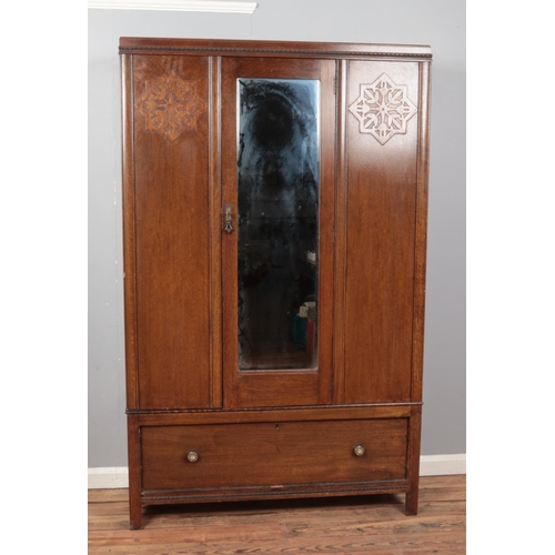 535 - A three-piece oak and ply bedroom suite, comprising of mirrored wardrobe, chest of drawers and mirro... 