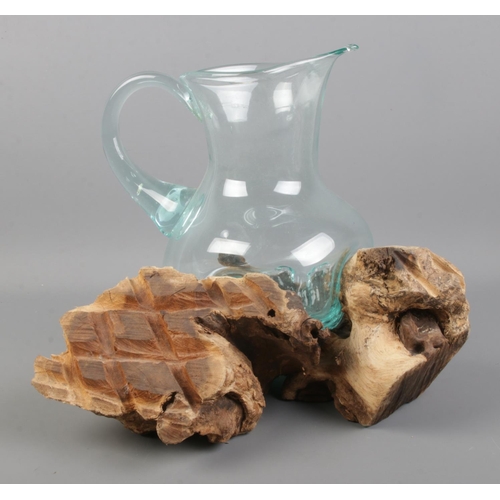 100 - A molten glass jug contained within a driftwood root sculpture. Height: 25cm.