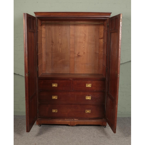 506 - A large mahogany compactum wardrobe with carved doors and plinth top.

Hx203cm
Wx130cm
Dx58cm