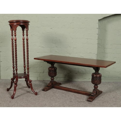 509 - A low oak coffee table with extensively carved pineapple supports, together with a mahogany jardinie... 