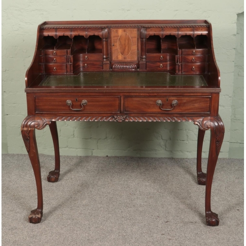 520 - A carved mahogany desk set with leather inset top. Approx. dimension 101cm x 60cm x 108cm.