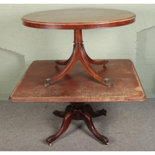 527 - Two mahogany tables. Includes a large rectangular mahogany dining table. Raised on turned central co... 