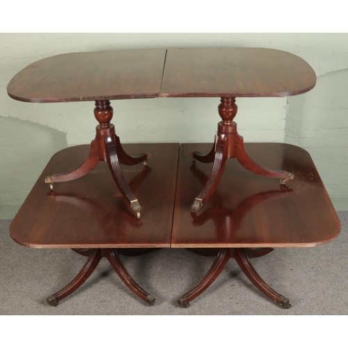 529 - Two mahogany twin pedestal dining tables. Includes a 20th century Regency style example, etc.