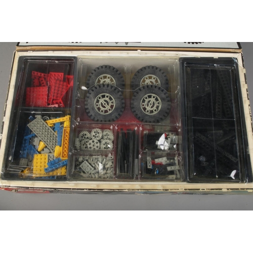 128 - A Lego 8860 technical set, box is open with parts organised into compartments, set unchecked for com... 