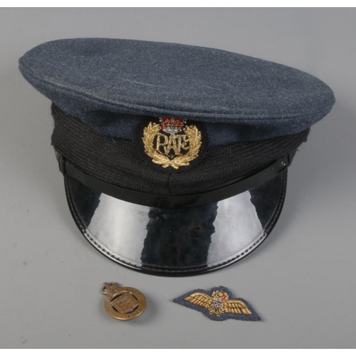 130 - An RAF cap and sew on badge along with a World War One On War Service lapel badge.