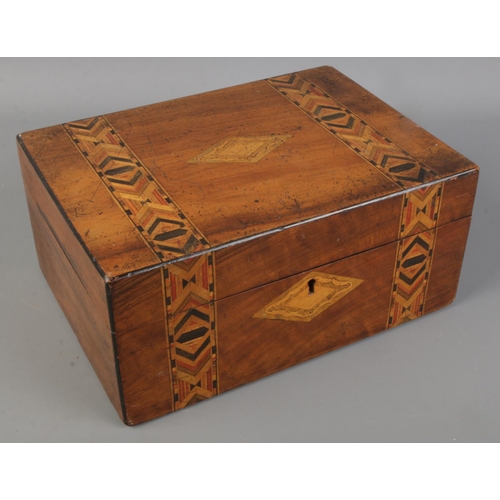 131 - A marquetry box with contents of cigarette cards. Includes Players, Wills, Ogdens, etc.