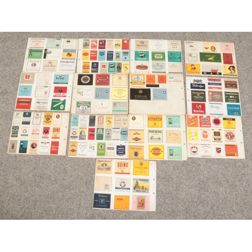 135 - A large quantity of vintage cigarette packets mounted on card (double sided).