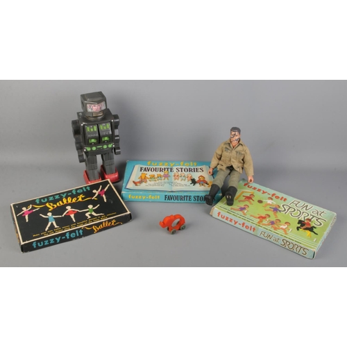 136 - A quantity of toys. Includes robot, Action Man, Fuzzy Felts and a bakelite elephant.