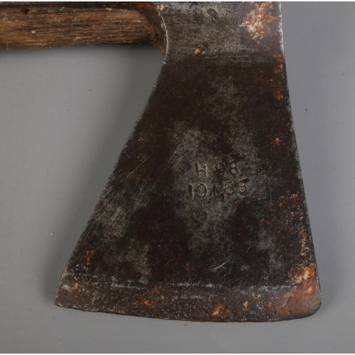 142 - A Brades wooden handle fire axe, bearing military broad arrow mark and dated 1953, together with ano... 