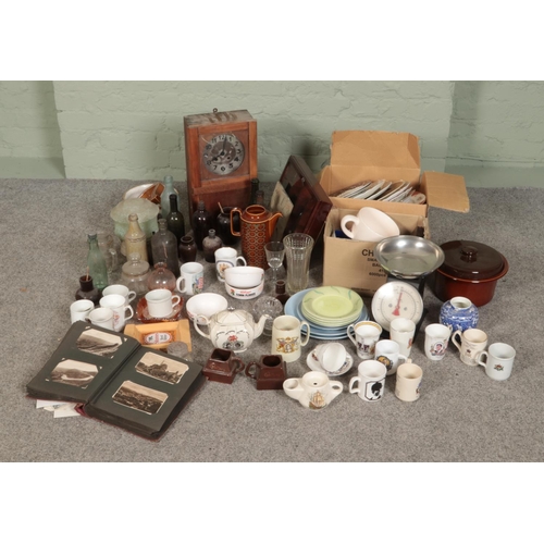 180 - A large mix of collectables including wall clock, mixed glass bottles, commemorative tea cups/mugs, ... 