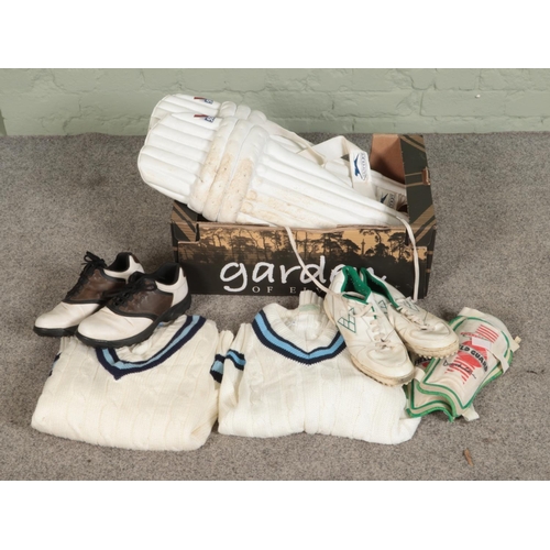 187 - A quantity of cricket kit including batting leg guards jumpers (XL & 42) and cricket shoes (UK 9)