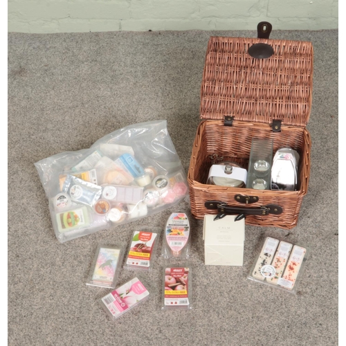 204 - A wicker basket and one bag of candles and wax melts to include Yankee candle examples.