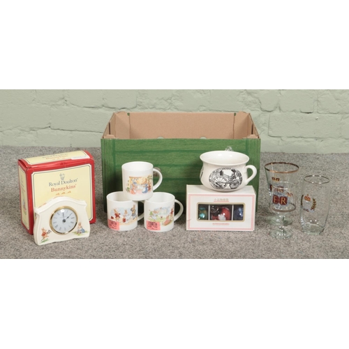 220 - A box of assorted items, to include three pairs of silver jubilee glasses, eight Bunnykins mugs, Roy... 