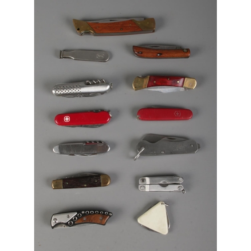49 - A collection of folding pen knives to include Swiss Victorinox and Wenger examples.