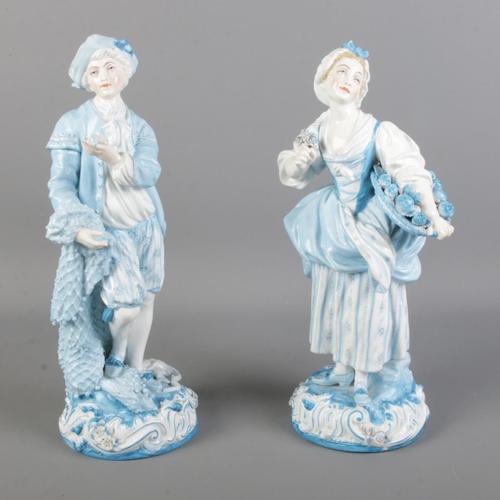 65 - Two Charles Levy Co. blue and white painted porcelain figures depicting a fruit carrier and a fisher... 