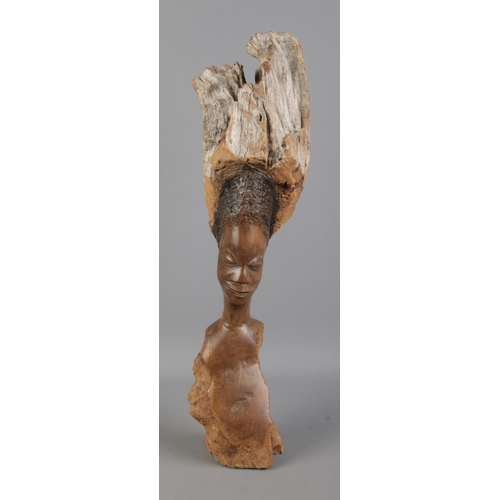 70 - An unusual wooden carving of the bust of a tribal woman. 50cm tall.