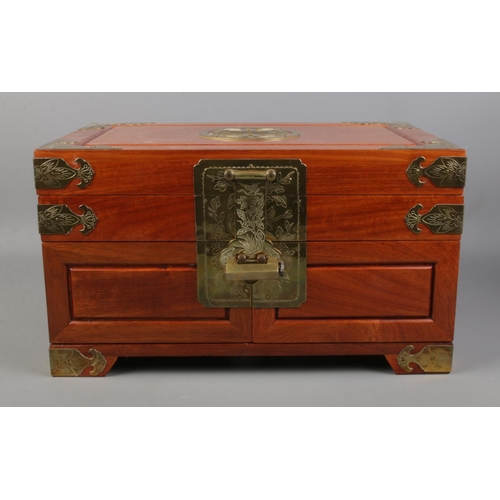 77 - A hardwood jewellery box with brass decoration, together with two bears riding a bicycle.