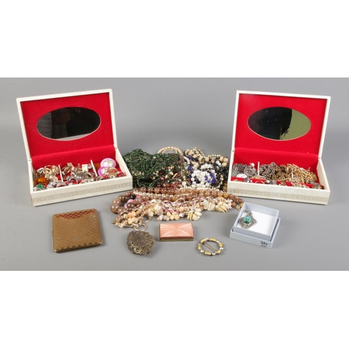 9 - Two jewellery boxes containing a collection of costume jewellery. To include rings, chains, beaded n... 