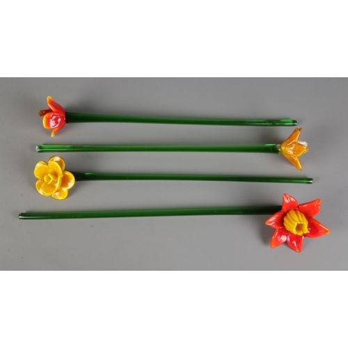 90 - Four art glass flowers with long stems each of a different flower. Approx. stem length 47cm.