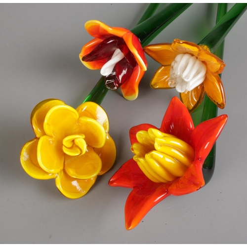 90 - Four art glass flowers with long stems each of a different flower. Approx. stem length 47cm.