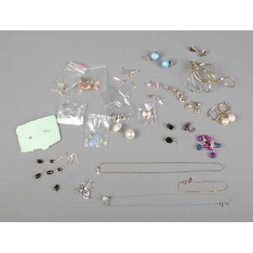 96 - A collection of costume jewellery earrings including simulation pearl and stud examples along with s... 