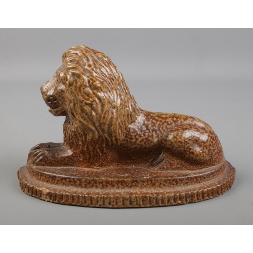 98 - A salt glaze lion in recumbent pose.

Hx10cm