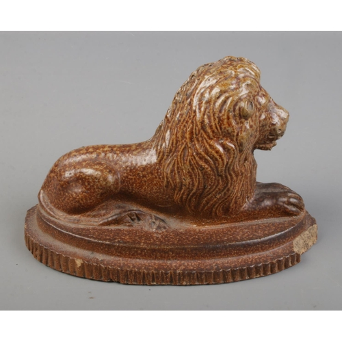 98 - A salt glaze lion in recumbent pose.

Hx10cm