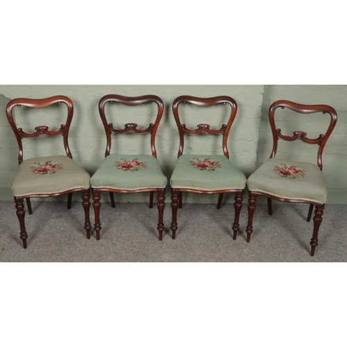 486 - A set of four Victorian rosewood dining chairs with embroided upholstery.