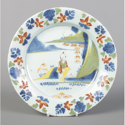 1 - A pair of 18th century London Delft polychrome plates, both decorated with a seated Chinese man and ... 