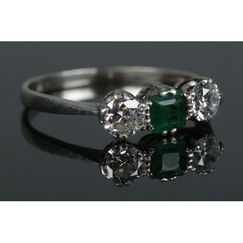 100 - An Art Deco platinum, diamond and emerald ring. Size M. 2.57g. Total diamond approximately 0.5ct.