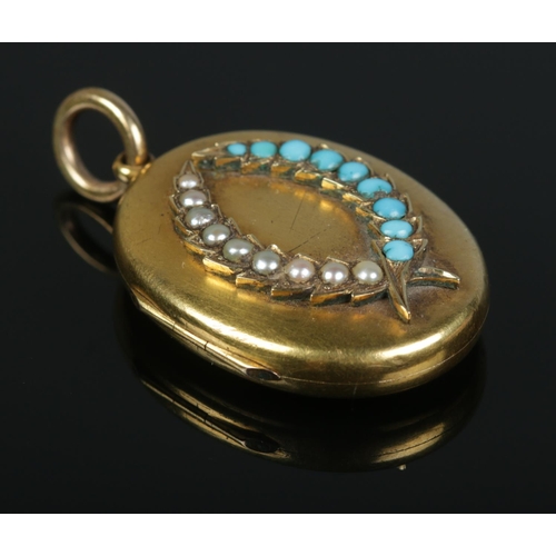 104 - A Victorian gold locket with seed pearl and turquoise set laurel decoration. 11.04g. Tests as 15ct. ... 