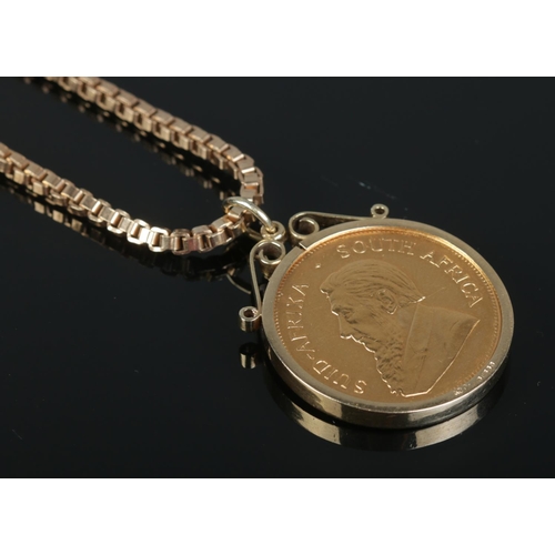 106 - A South African gold Krugerrand, dated 1975, in 9ct gold mount on 9ct gold box chain. Chain 41.95g. ... 