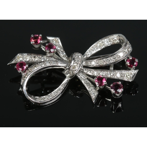 108 - An Art Deco inspired 18ct white gold, diamond and ruby bow brooch. Hallmarks for Sheffield 1977, mak... 